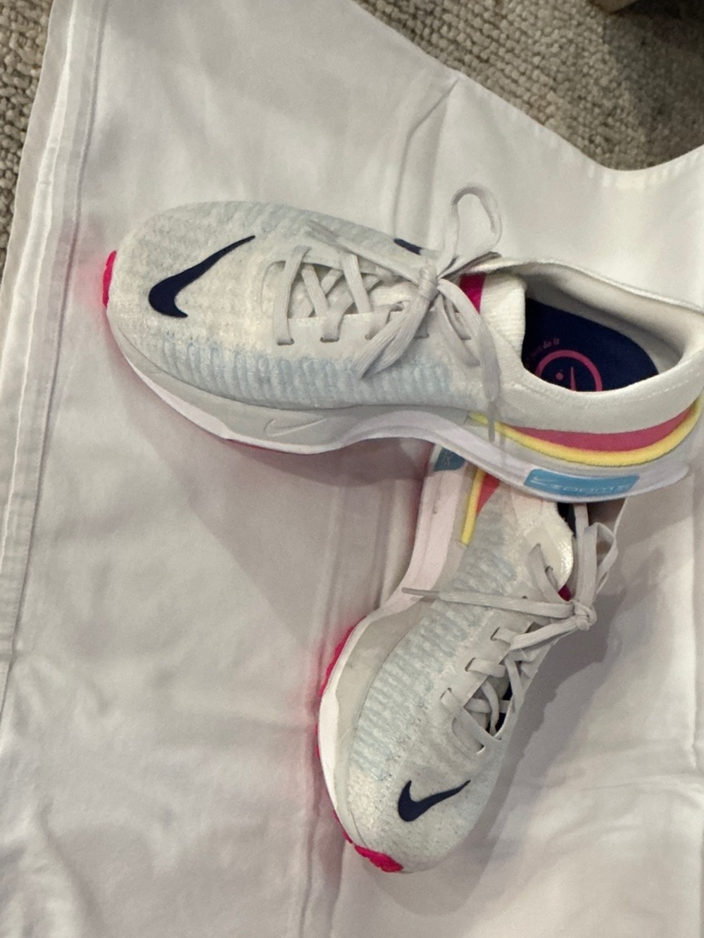 Nike Kids White Sneakers with Navy Swoosh and Multicolor Heel Stripes